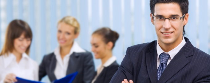 Portrait of successful businessman and business team at office