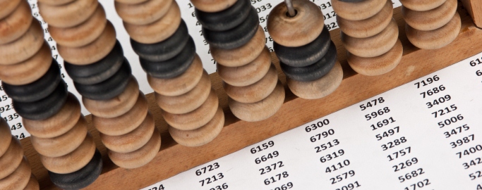 old wooden abacus on background working papers